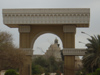 Arch With Saddam’s Bust In The Distance
