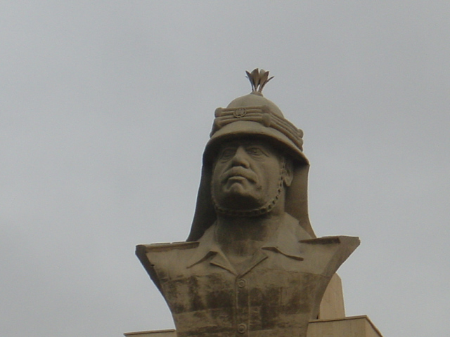 Bust of Saddam In Front of Palace