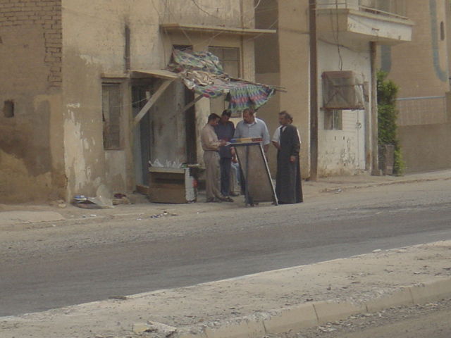 Men Outside An Open Shop