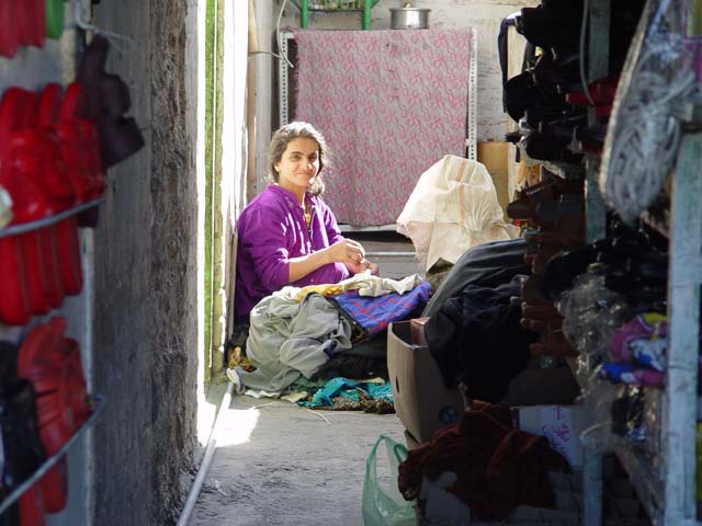 Woman Sewing In Alley