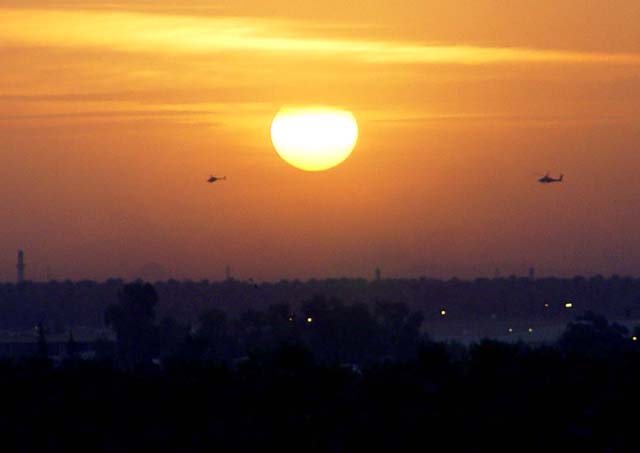 Two Helicopters At Sunset In Baghdad 