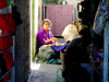 Woman In Purple Working In A Baghdad Alley